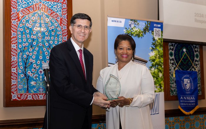 NAU's Dr. Taban presenting an award to Houston Airport System's Rhonda Arnold