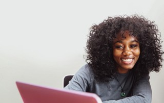 an NAU Student smiling while studying in the NAU Library