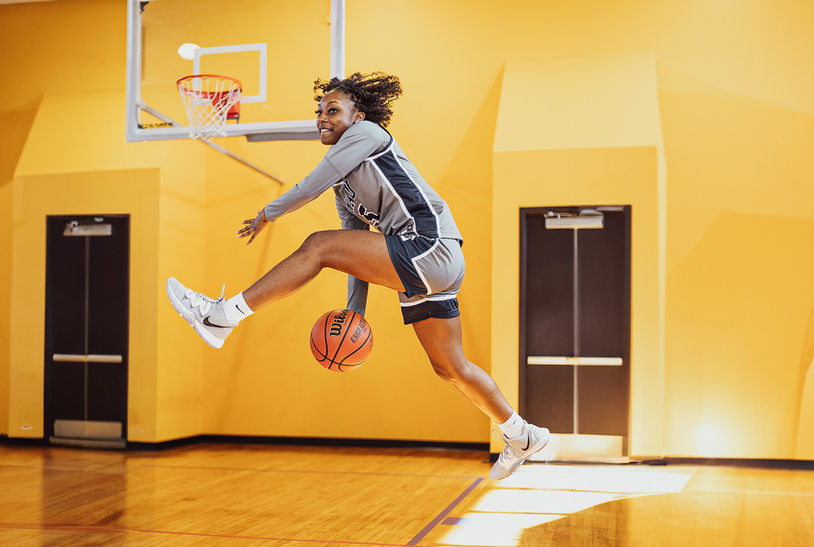 Keiarra Rivers of NAU passing the ball between her legs