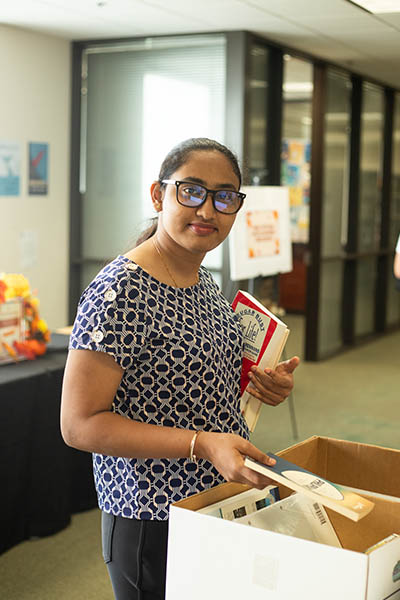 book1 Student picking up books at the NAU library
